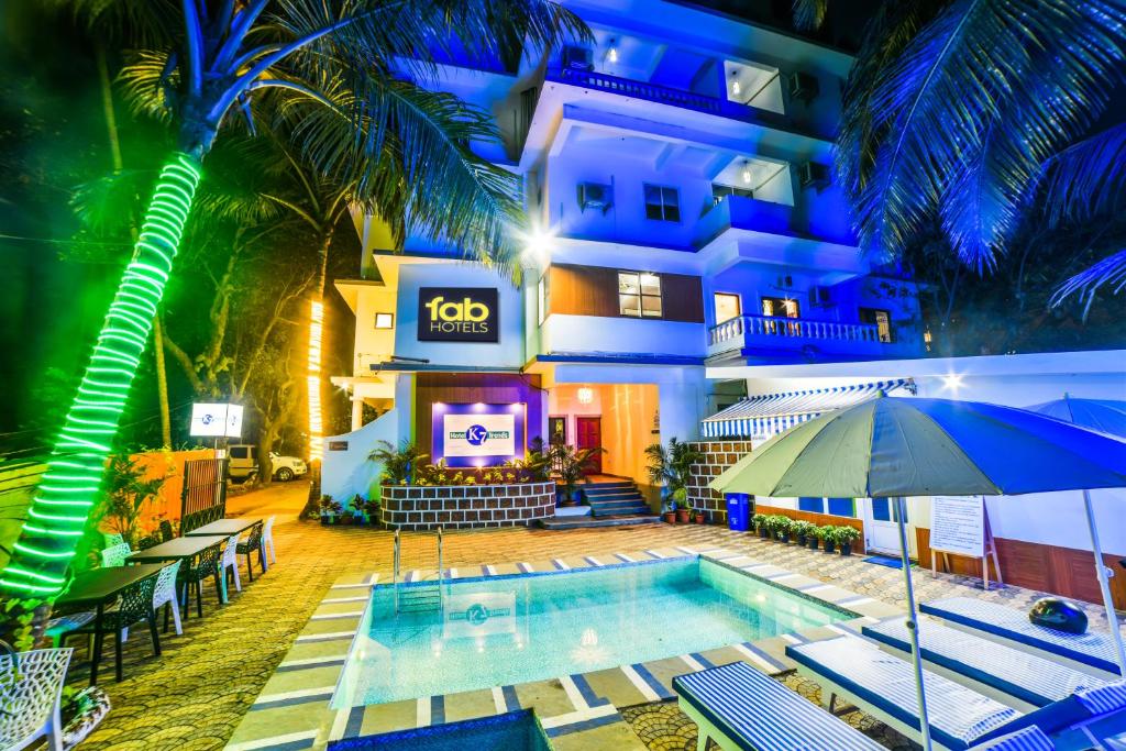 a hotel with a swimming pool in front of a building at FabHotel K7 Trends With Pool, Baga Beach - Nr Baga Beach in Calangute