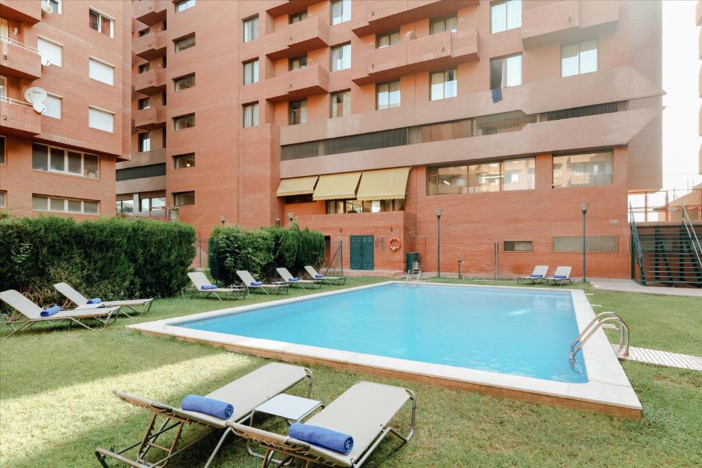 a swimming pool in front of a building at Hesperia Sant Joan in Sant Joan Despí