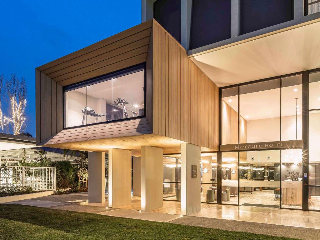 una casa moderna con una grande facciata in vetro di Mercure Sydney Rouse Hill a Kellyville