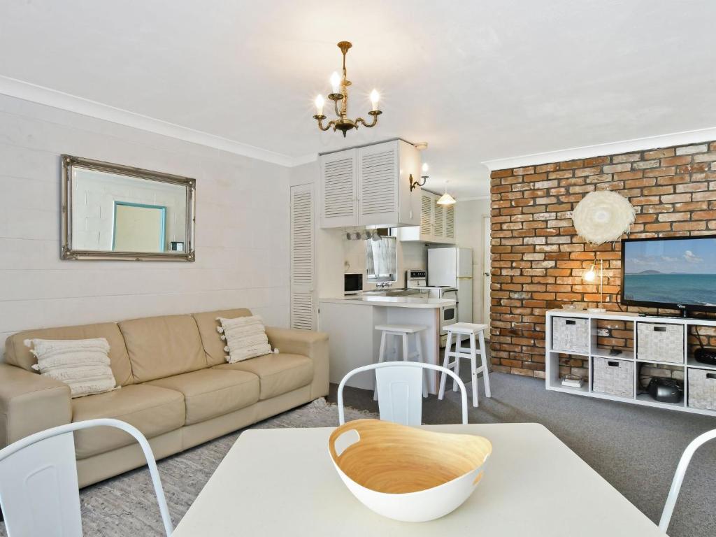 a living room with a couch and a table at Blueys Beach Villa Manyana 11 in Blueys Beach