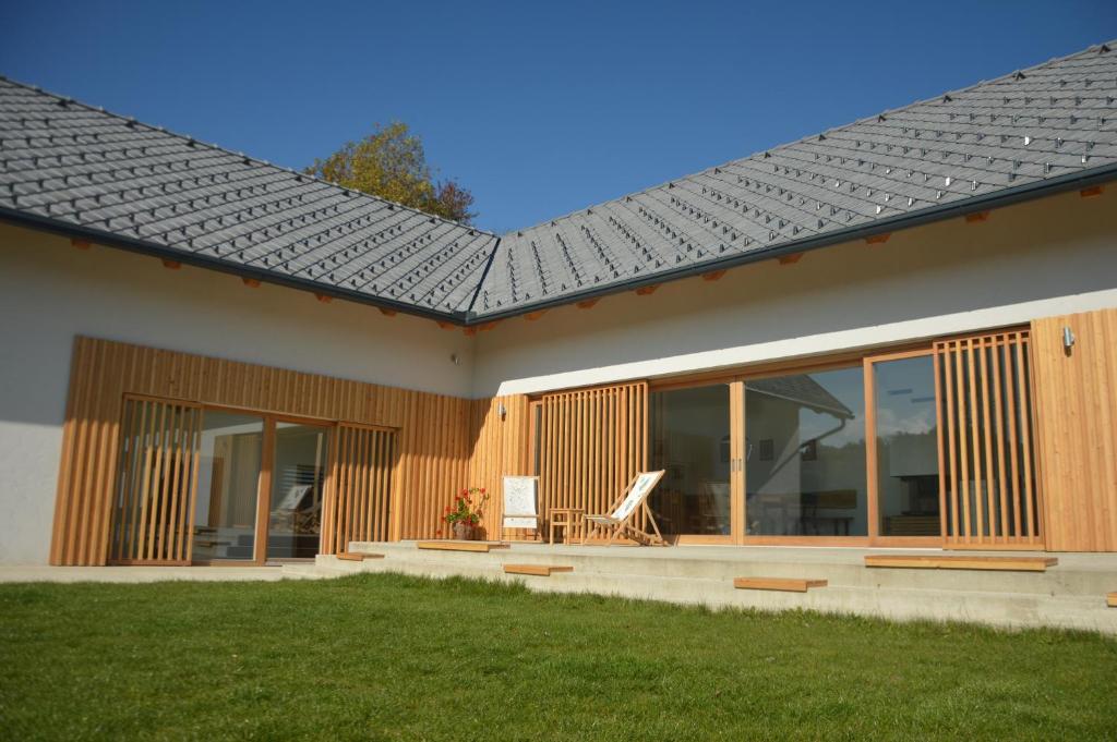 a house with a metal roof on top of it at Hiša sonca Toti breg in Svečina