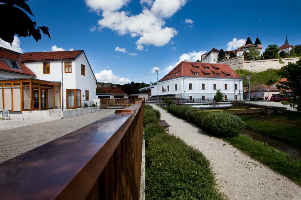 einen Zaun vor einem Gebäude mit Häusern in der Unterkunft Gizella Hotel and Restaurant in Veszprém