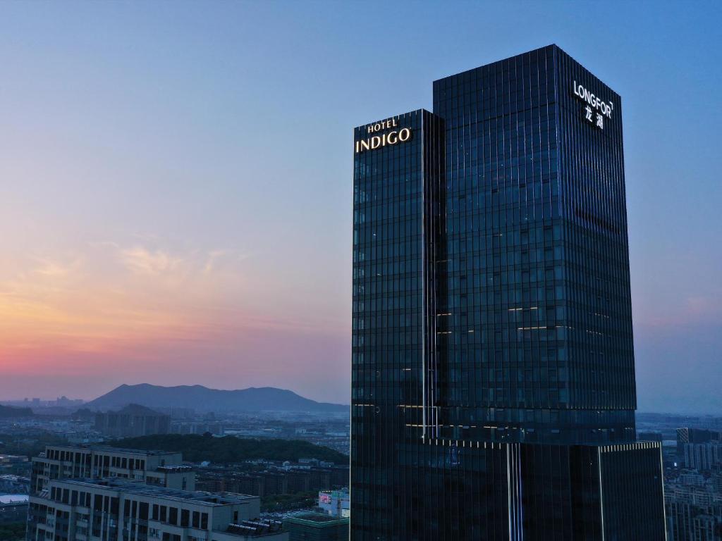 a tall building with a sign on the side of it at Hotel Indigo Suzhou Grand Canal, an IHG Hotel in Suzhou