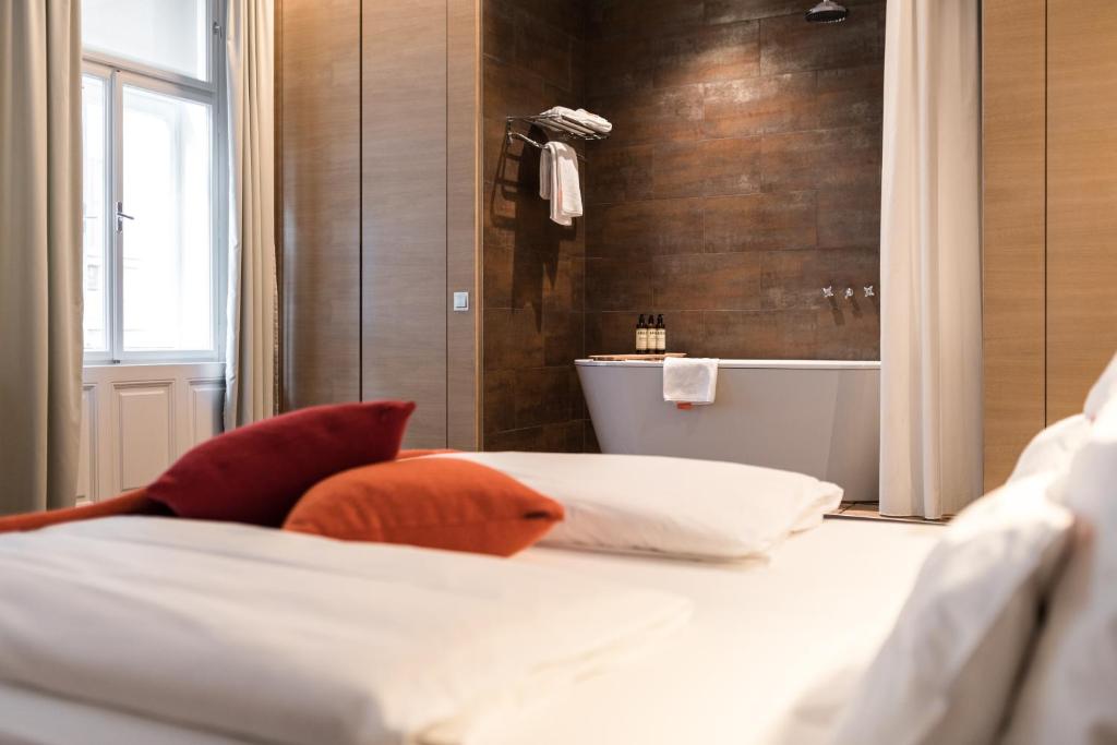 A bed or beds in a room at Hollmann Beletage Design & Boutique Hotel