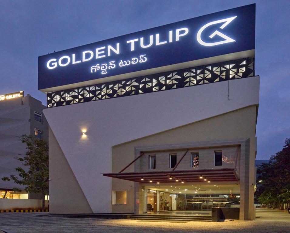 un edificio con un cartel en el costado en Golden Tulip Tirupati en Tirupati