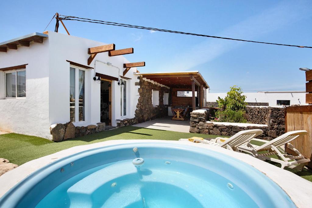 a swimming pool in front of a house at Ca Lajares in Lajares