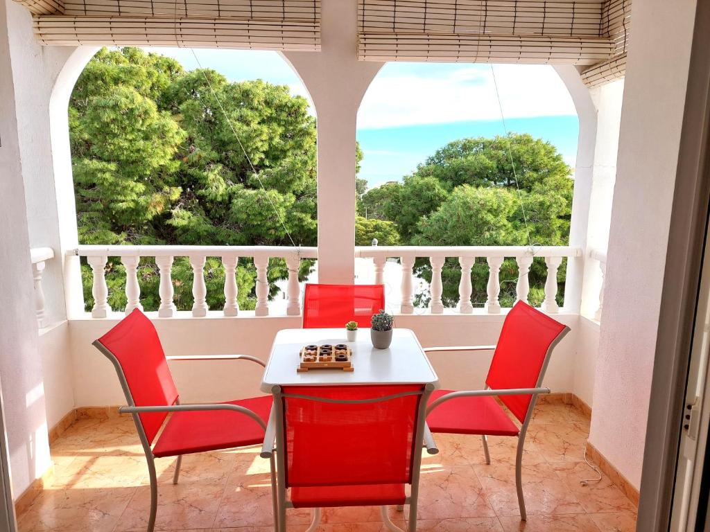 a table and chairs on a balcony with a view at Casa Azabara in San José