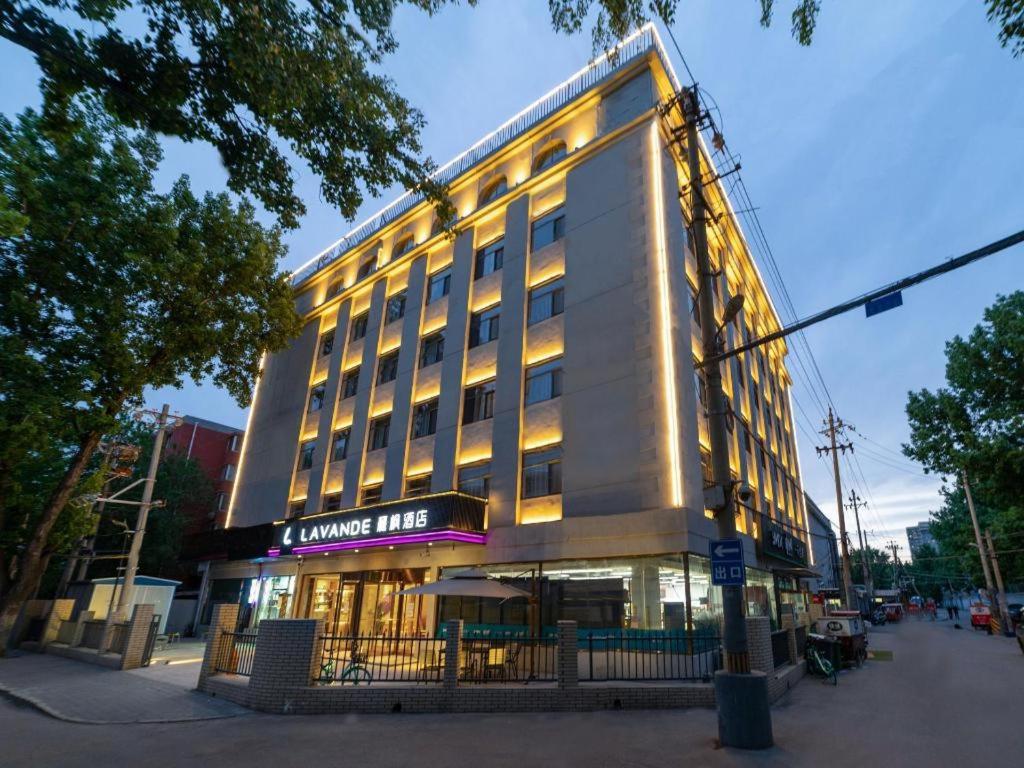 a large building with lights on top of it at Lavande Hotel Beijing International Exhibition Heping Xiqiao Metro Station in Beijing