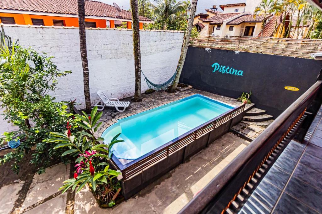 una piscina al aire libre con un columpio en un complejo en Pousada Maré Alta - MARESIAS, en Maresias