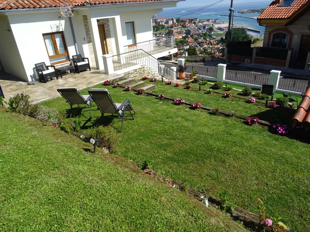 un cortile con due sedie su una casa di LA CASA DE VIOLETA a Suances