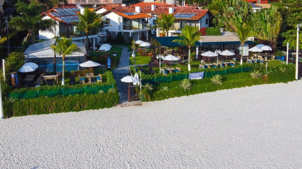 an aerial view of a resort with tables and umbrellas at Hotel Sete Ilhas in Florianópolis