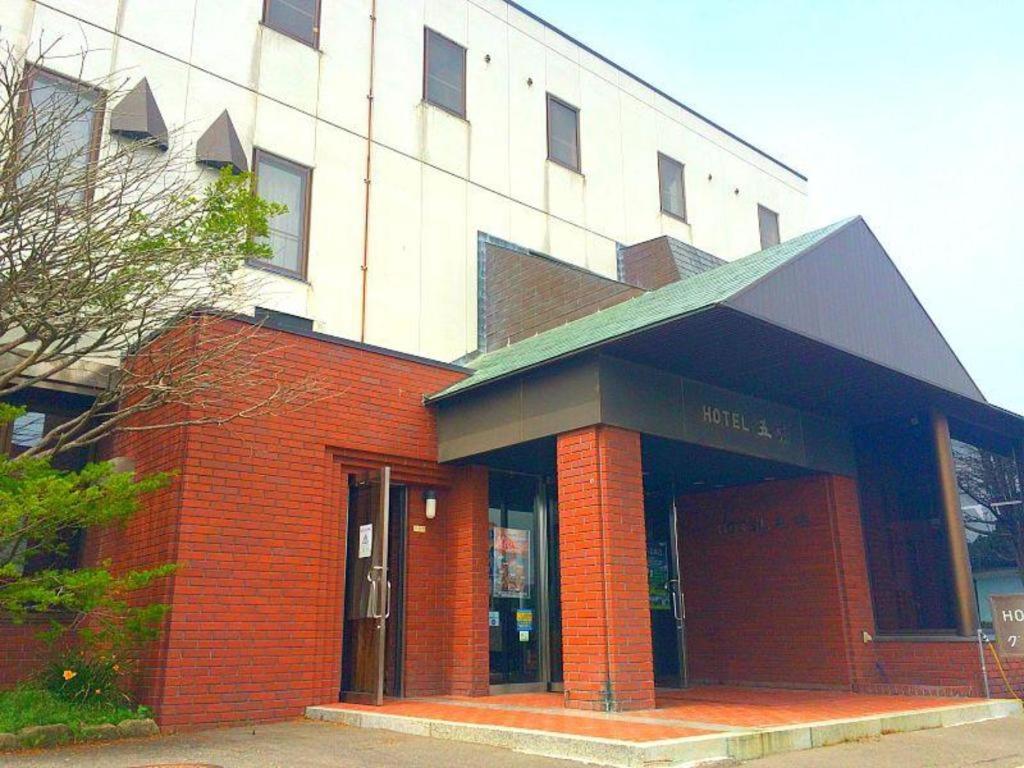 a red brick building with a building at Hotel Gomi in Kushiro