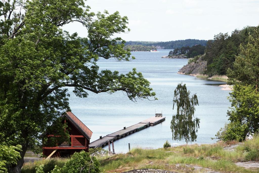 a view of a lake with a dock on the water at Skeviks Gård in Gustavsberg