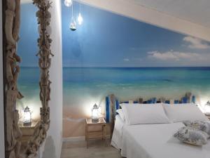 Katil atau katil-katil dalam bilik di Acquamarina b&b