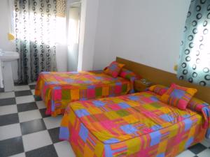 A bed or beds in a room at La Esteponera