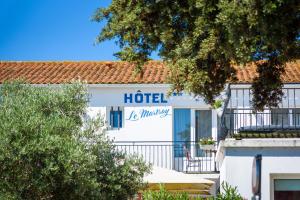 a hotel sign on the side of a building at Hôtel Le Martray in Ars-en-Ré