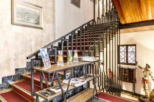 a staircase in a house with a shelf of wine bottles at Hotel Sercotel Alfonso VI in Toledo