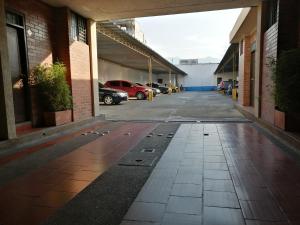 un couloir vide d'un parking avec des voitures garées dans l'établissement LA POSADA DEL VIAJERO, à Ibagué