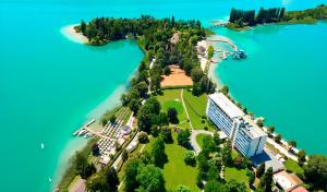 an island in the middle of a body of water at Parkhotel Pörtschach - Das Hotelresort mit Insellage am Wörthersee in Pörtschach am Wörthersee