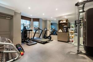 a gym with treadmills and exercise equipment in a room at Radisson Blu Hotel, London South Kensington - formerly Vanderbilt in London