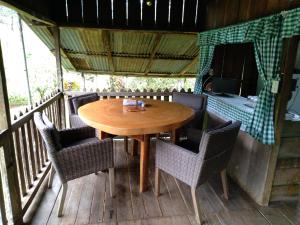 un tavolo e sedie in legno su una terrazza di Finca Sueno de Osa a Puerto Jiménez