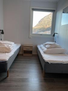 A bed or beds in a room at Hardangerpark AS