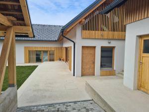 an external view of a house with wooden doors at Hiša sonca Toti breg in Svečina