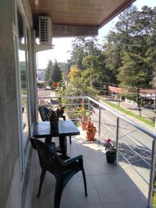 a porch with a table and chairs on a balcony at Str.Agmashenebeli 548 in Kobuleti