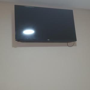 a flat screen tv hanging on a wall at Royal Hotel in Sao Paulo