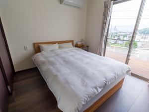 Krevet ili kreveti u jedinici u objektu Rakuten STAY HOUSE x WILL STYLE Sasebo 106