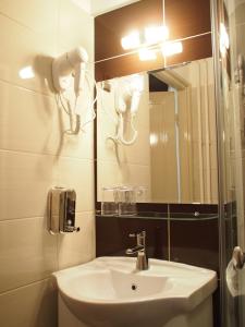 a bathroom with a sink and a mirror at Budapest Suites in Budapest