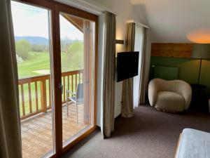 een kamer met een balkon en een glazen schuifdeur bij Sapia Hotel Rheinsberg in Bad Säckingen