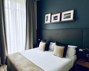 a bedroom with a bed with two pictures on the wall at Apartments Sixtyfour in Barcelona