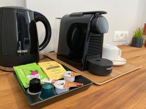 uma bandeja com comodidades para preparar café ao lado de um micro-ondas em Good Mood - chambres et suite em Namur