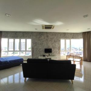 イポーにあるOctagon Premium Ipoh Town Center 2BR 121 by Grab A Stayのリビングルーム(ソファ、ベッド付)