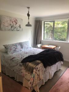 a bedroom with a bed and a window at Almost Heaven BNB in New Plymouth