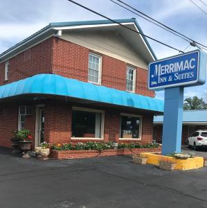 a red brick building with a sign in front of it at MERRIMAC INN & SUITES in Williamsburg