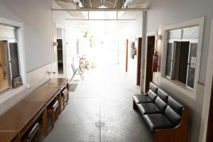 a hallway with a leather couch in a room at Hostel Diniz in Vitória