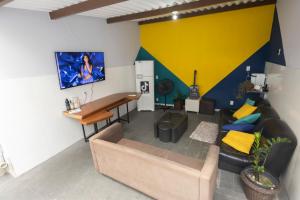 a living room with a couch and a table at Hostel Diniz in Vitória