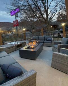 a patio with a couch and a fire pit at The Gonzo Inn in Moab