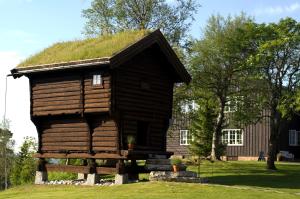 a log cabin with a grass roof at Lysebu Hotel in Oslo