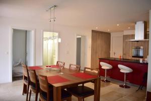 a kitchen and dining room with a wooden table and chairs at Modern Apartment 모던 펜션 in Interlaken