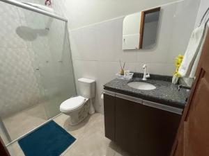 a bathroom with a shower and a toilet and a sink at Flat hotel Victoram in Rio Branco