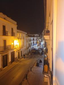 a view of a street at night with buildings at Habitaciones La Flamenka in Ronda