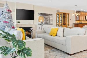 a living room with a white couch and a christmas tree at PERFECT 5 STAR - Chelsea Harbor House in Atlantic City