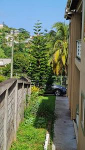 a car driving down a street next to a building at Coconut Creek Deluxe Suite in Hyde Park