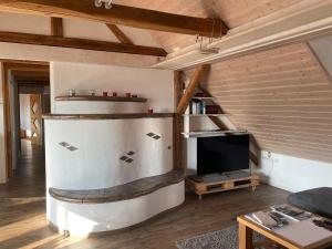 a living room with a large refrigerator and a tv at Sonniges Ferienapartment am Alten Binauer Schloss 