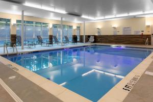 a large swimming pool with blue water in a building at Fairfield Inn & Suites by Marriott Atlanta Marietta in Marietta