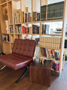 una silla frente a una estantería con libros en Good Morning Mölndal en Mölndal