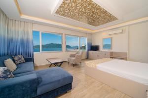 a hotel room with a bed and a couch at Moda Beach Hotel in Marmaris